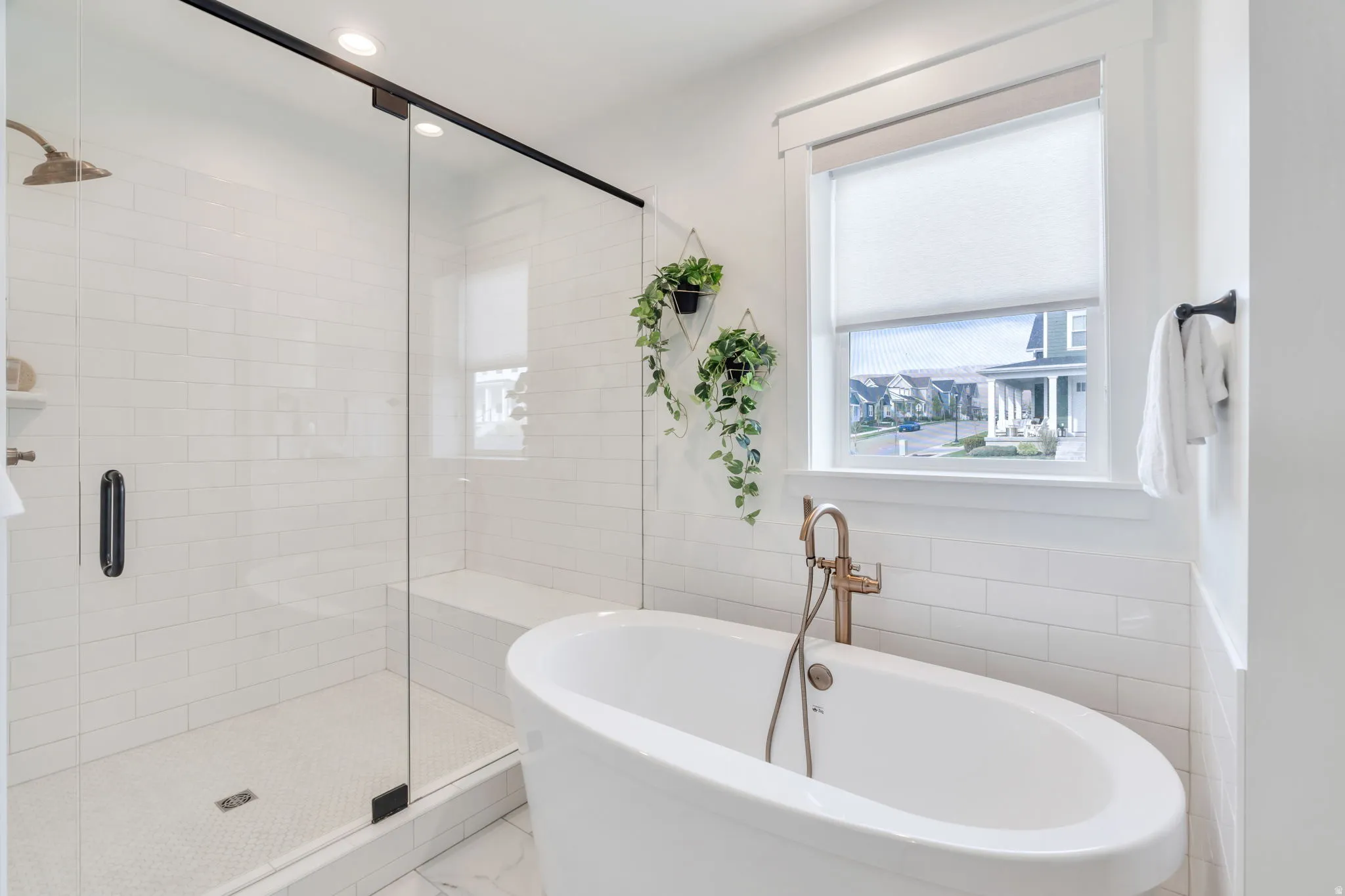 Full bath with a stall shower, a soaking tub, tile walls, and recessed lighting