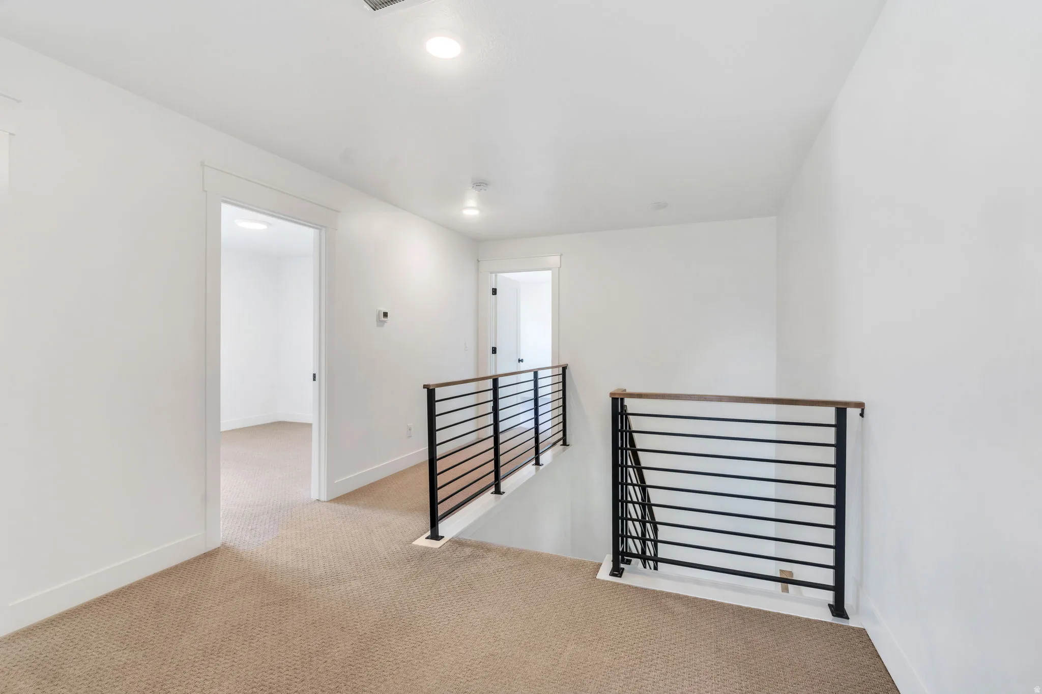 Empty room featuring light carpet and recessed lighting