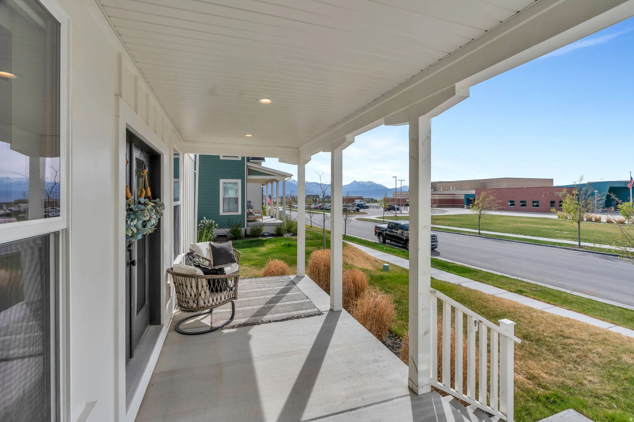 Covered porch featuring a mountain view and a yard