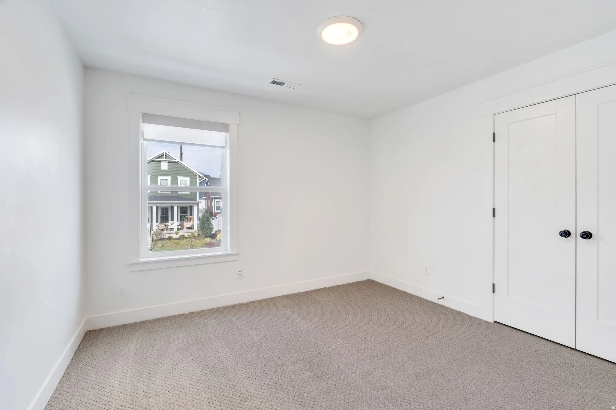 Unfurnished bedroom with carpet and baseboards