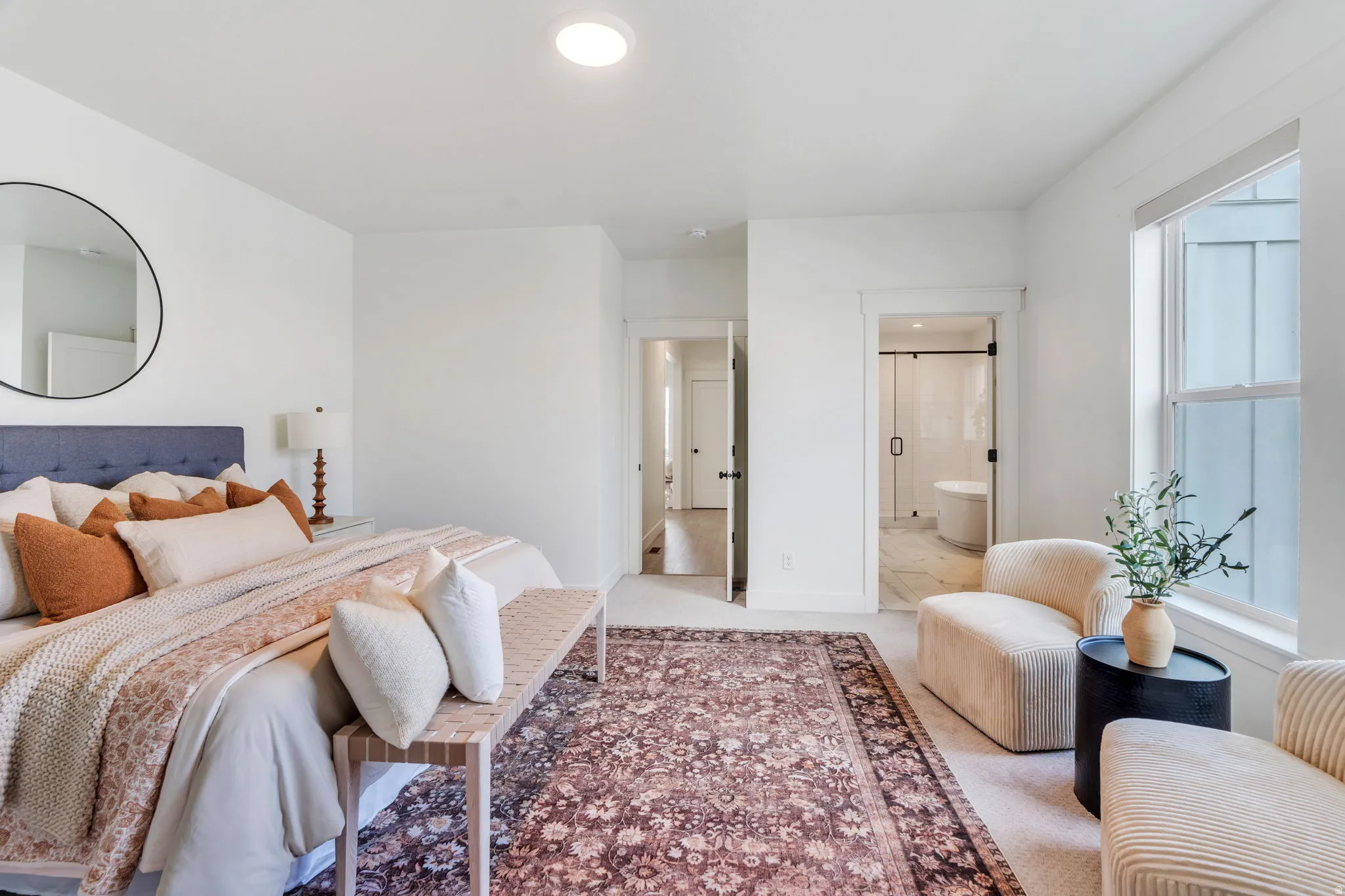 Bedroom featuring ensuite bath and light carpet