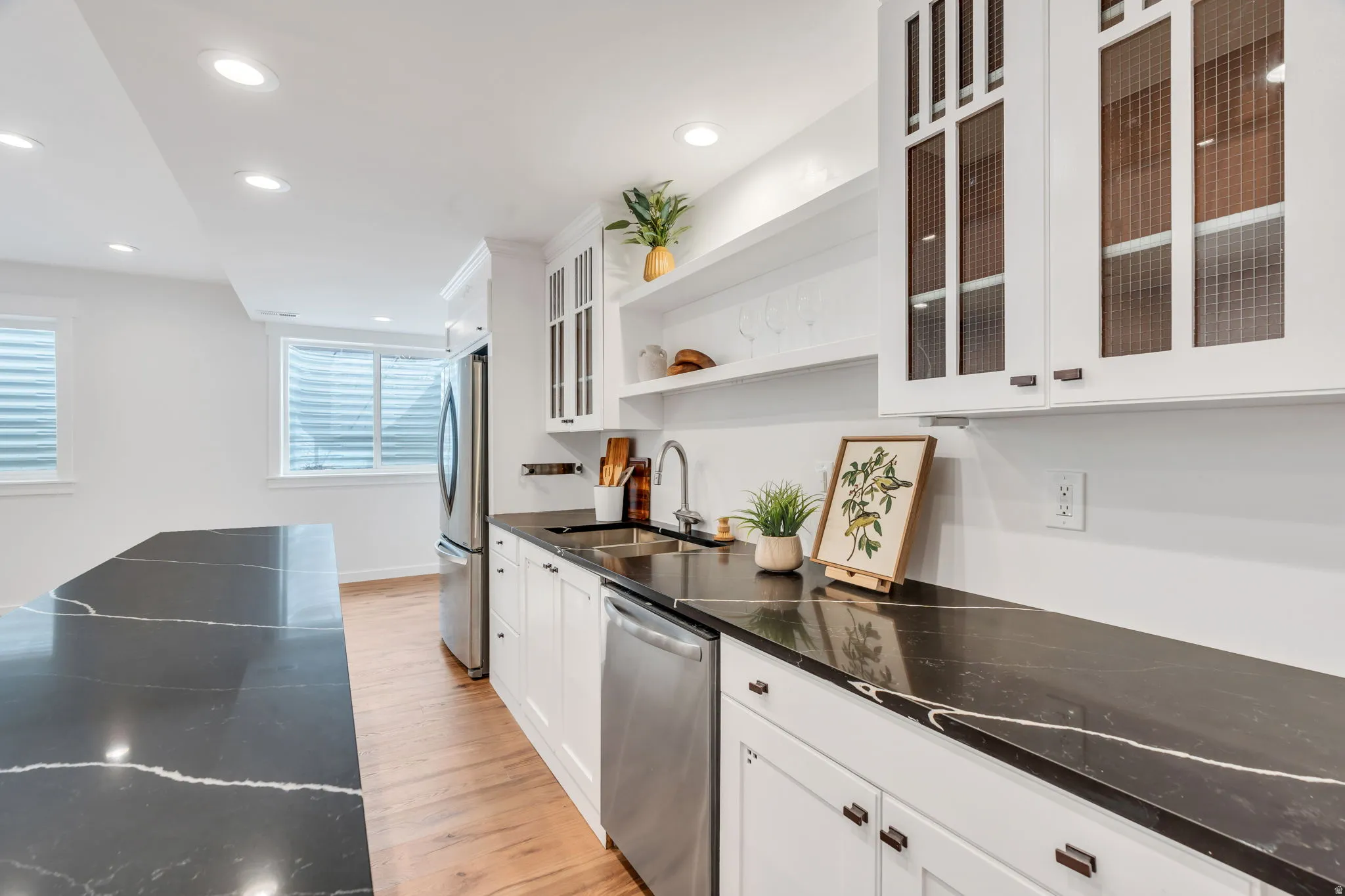 Kitchen with white cabinetry, open shelves, recessed lighting, light wood-style flooring, and stainless steel appliances
