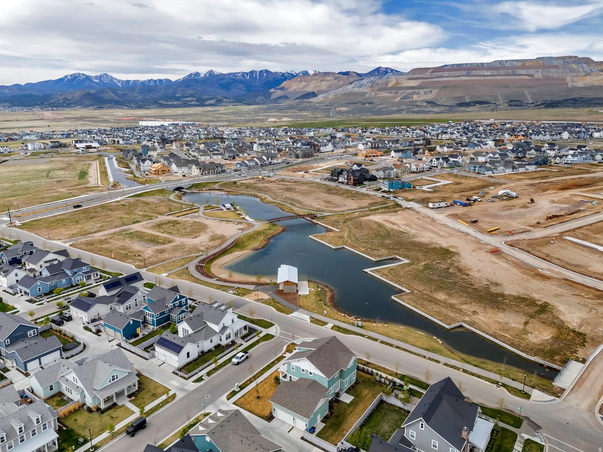Aerial view of property and surrounding area with nearby suburban area and a water and mountain view