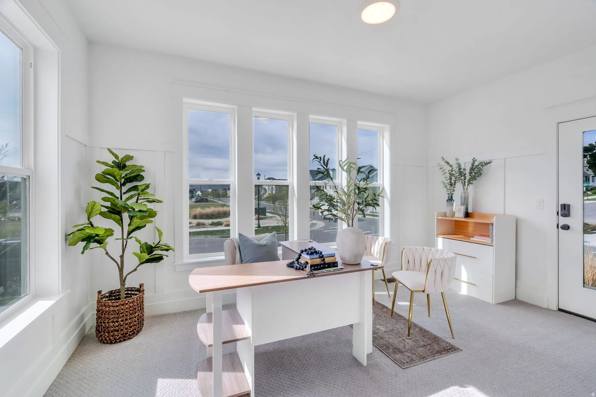 Office with light colored carpet and a decorative wall