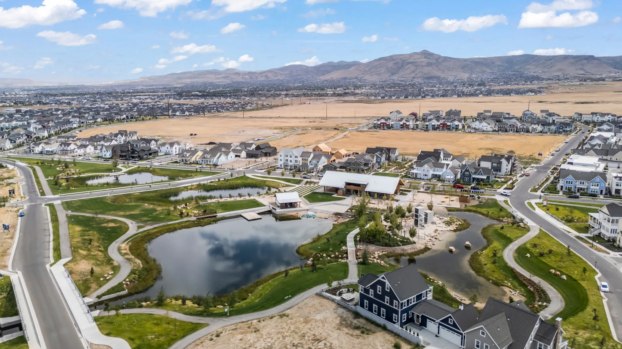 Aerial view of property's location featuring nearby suburban area and a water and mountain view