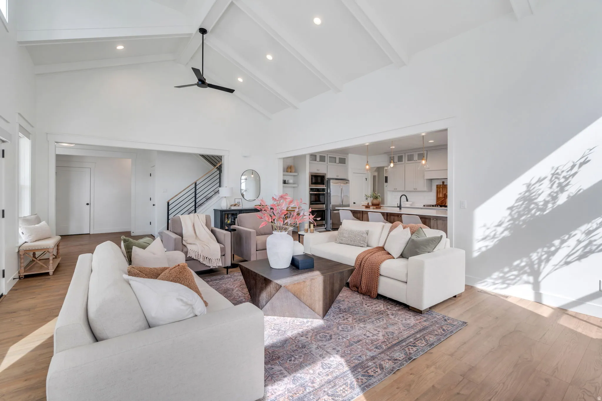 Living area with light wood finished floors, recessed lighting, and ceiling fan