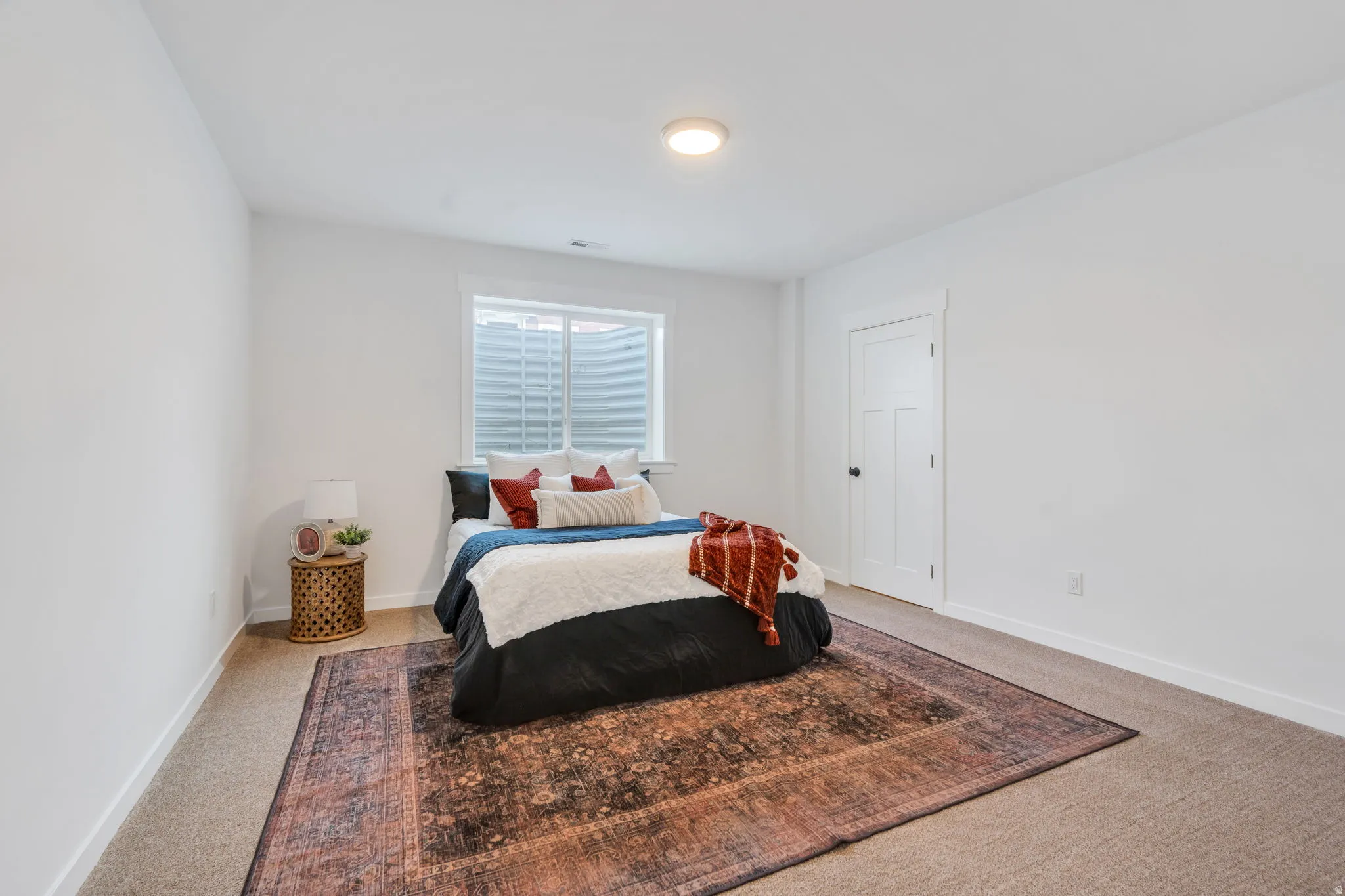 Bedroom with light colored carpet