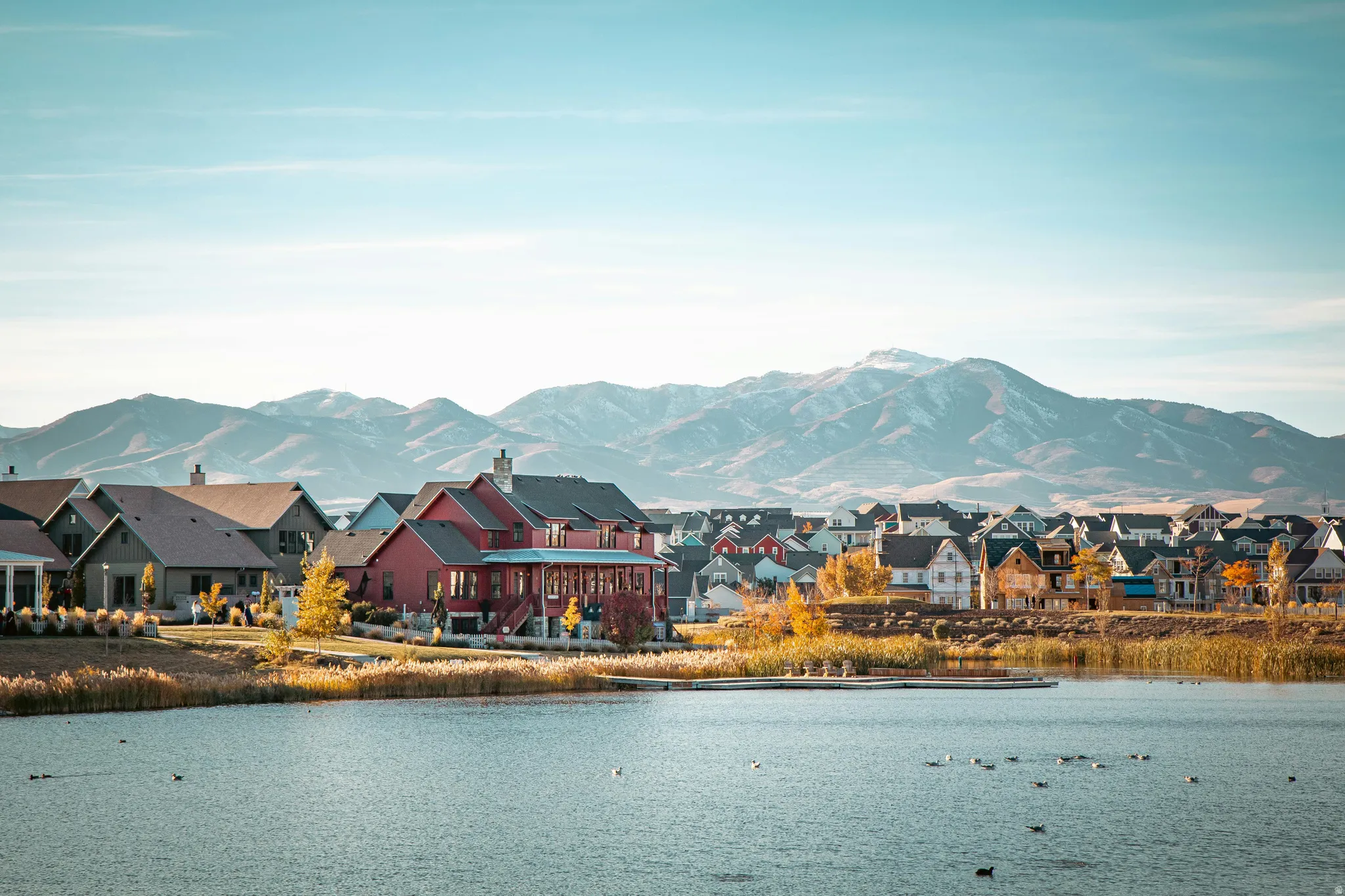 Water view featuring mountains and nearby suburban area