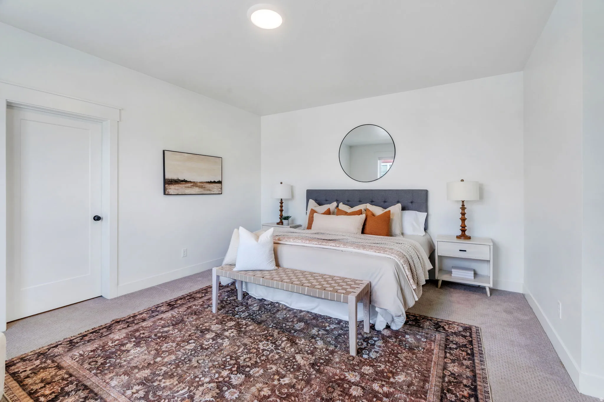 Bedroom with light carpet and baseboards