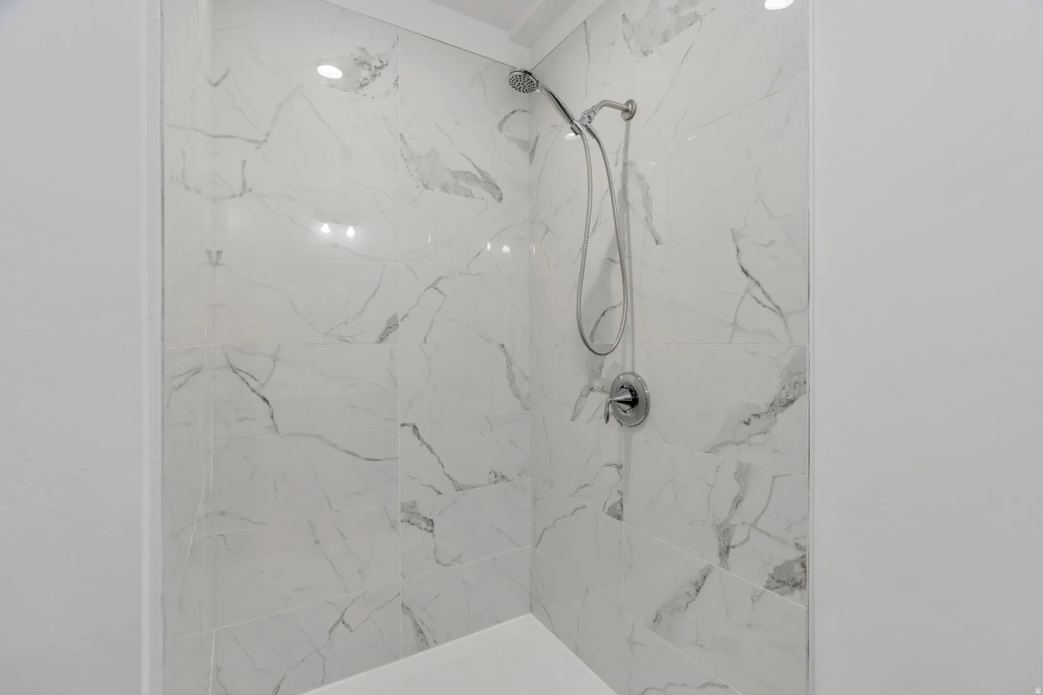 Bathroom with a marble finish shower