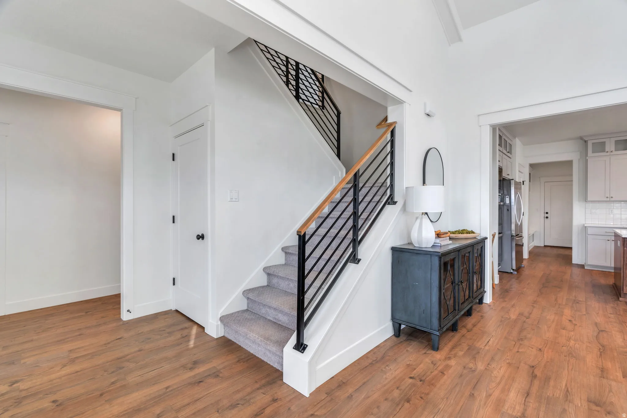 Staircase with wood finished floors and baseboards