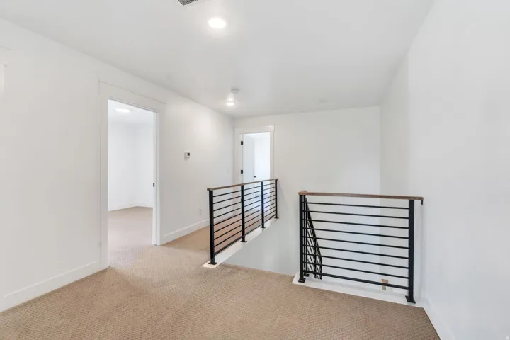Empty room featuring light carpet and recessed lighting