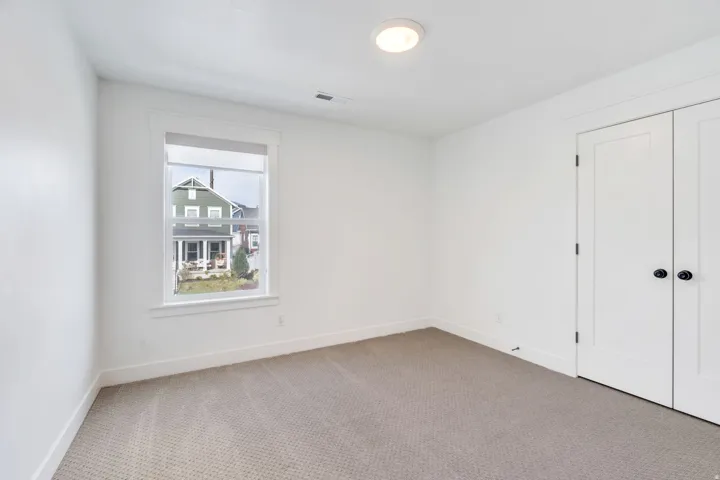 Unfurnished bedroom with carpet and baseboards