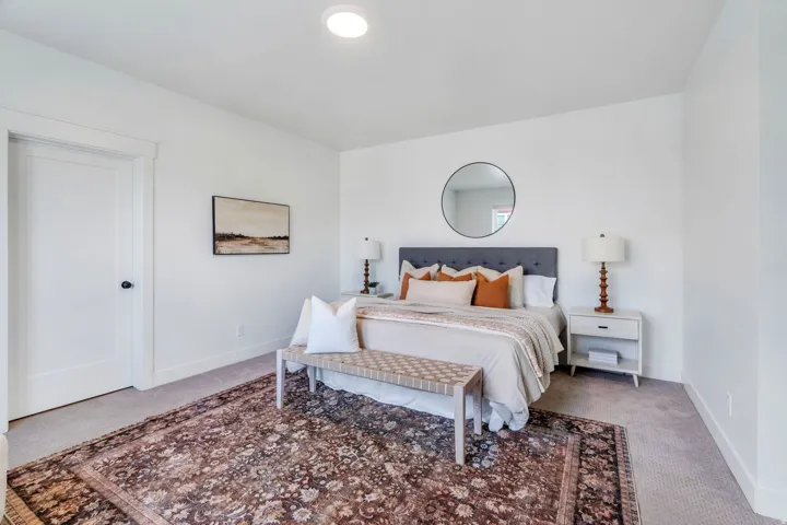 Bedroom with light carpet and baseboards
