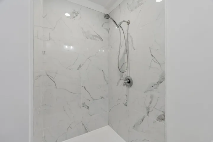 Bathroom with a marble finish shower