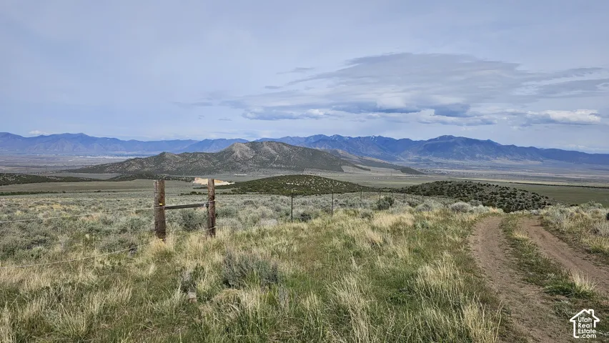 View of mountain backdrop with rural landscape