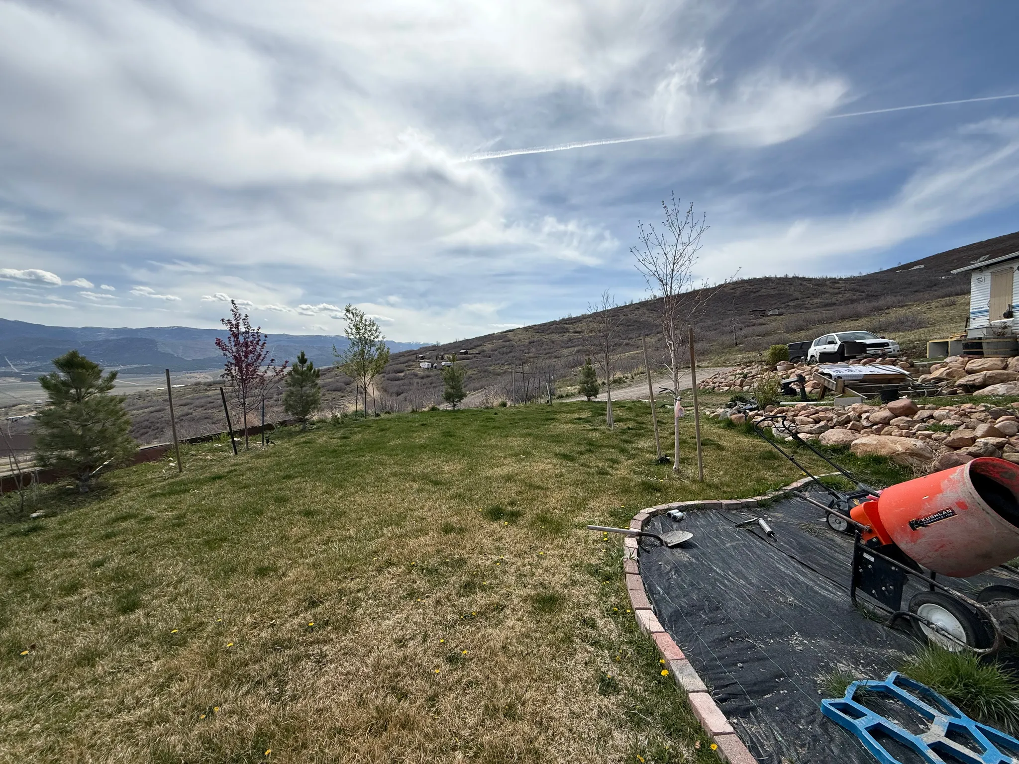 View of green lawn featuring a mountain view and a view of countryside