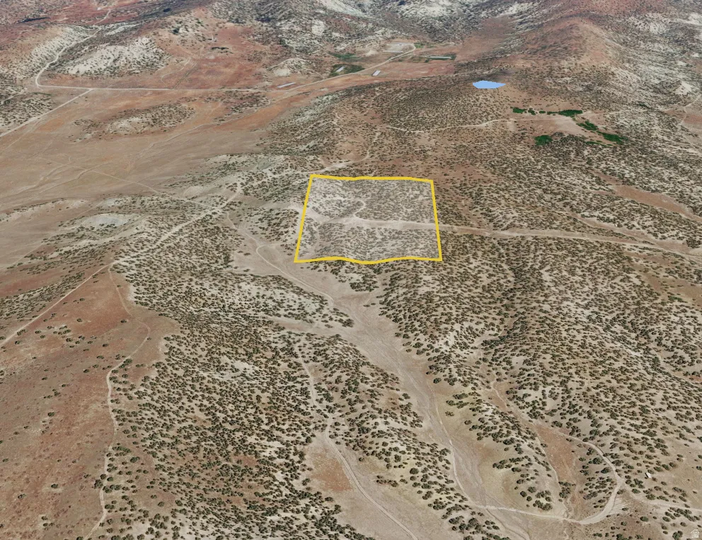 Expansive undeveloped land parcel outlined in yellow, featuring varied terrain and natural vegetation