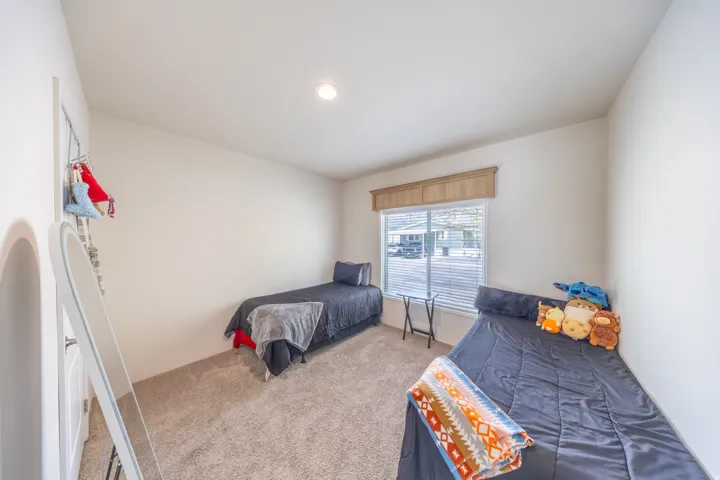 Bedroom featuring light carpet