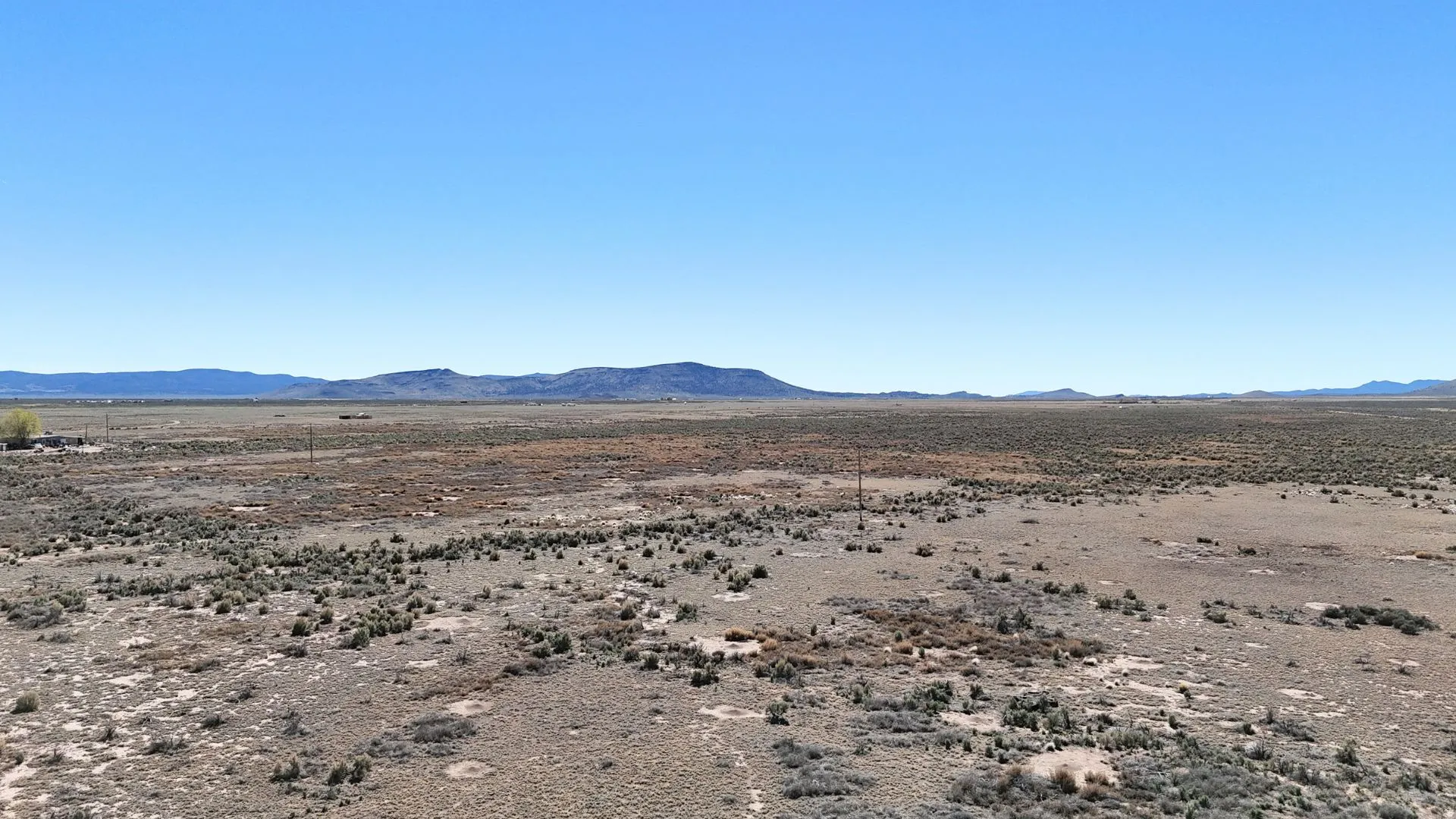 View of mountain backdrop with a desert landscape and rural landscape