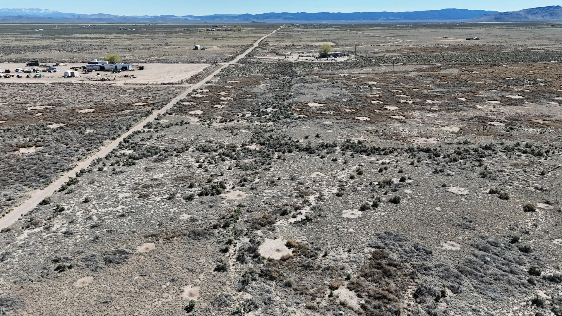 View of rural area with a desert landscape and a mountain backdrop