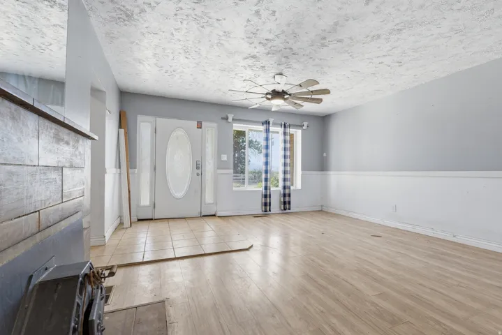 Entry area featuring a paneled door with oval glass, sidelights, and tiled flooring