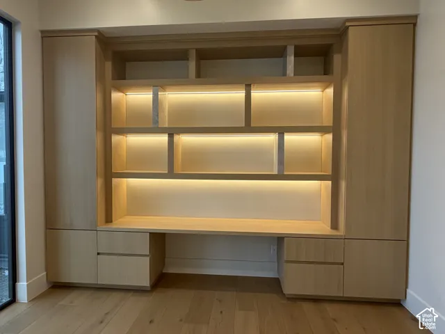 Built-in desk and shelving unit with integrated lighting