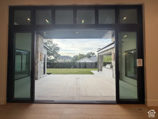 Viiew from the family room to the Spacious patio area. Massive sliding glass door that is flush with the floor beautifully merging the outdoor and indoor space for entertaining