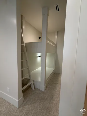 basement ensuite bedroom 2 with Built-in bunk bed system featuring a sturdy ladder and individual recessed lighting, walk in closet and full bathroom