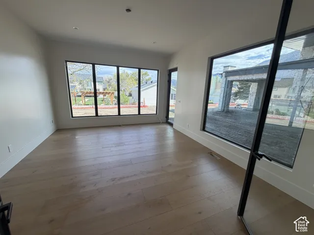 A great flex space on the main level with stunning windows to bring in light and a view of the backyard, with a door to the back patio. Perfect for a home gym or a media room