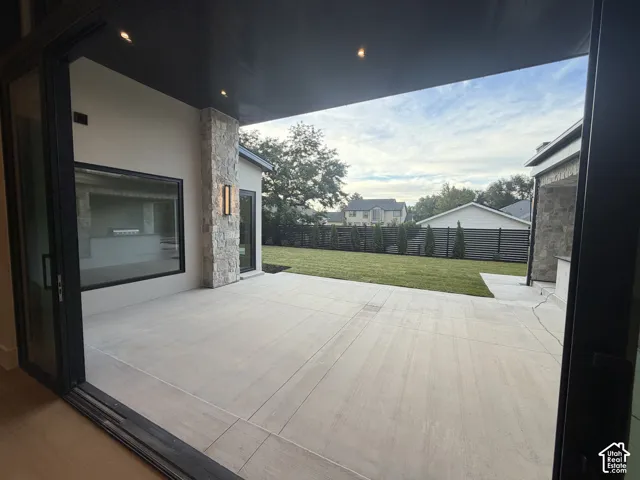 Expansive outdoor patio equipped with ceiling heaters for cold weather and misters for hot summers