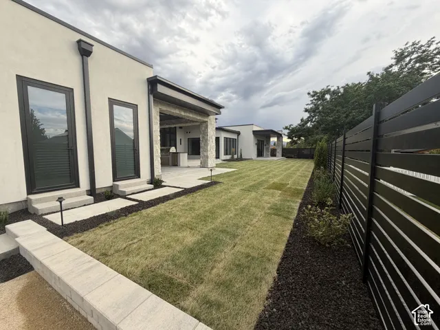 exterior featuring a stucco finish and black-framed glass doors