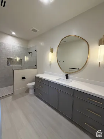 Spacious vanity featuring double basin functionality, white countertops, and abundant storage cabinetry