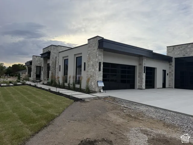 Modern exterior featuring light-colored stone and stucco finishes