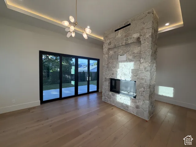 Primary bedroom with glass slide door that opens to its own private covered patio. Beautiful dual sided stone fireplace, trey ceiling with mood lighting and hardwood floors