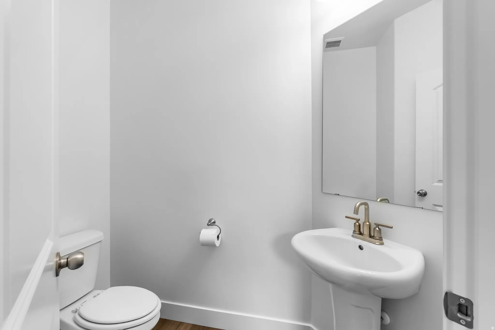 Bathroom with baseboards and wood finished floors