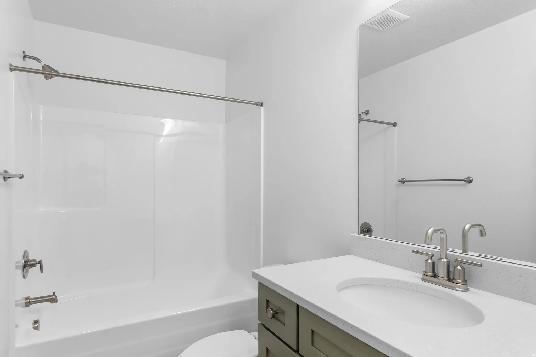Bathroom with vanity and bathing tub / shower combination
