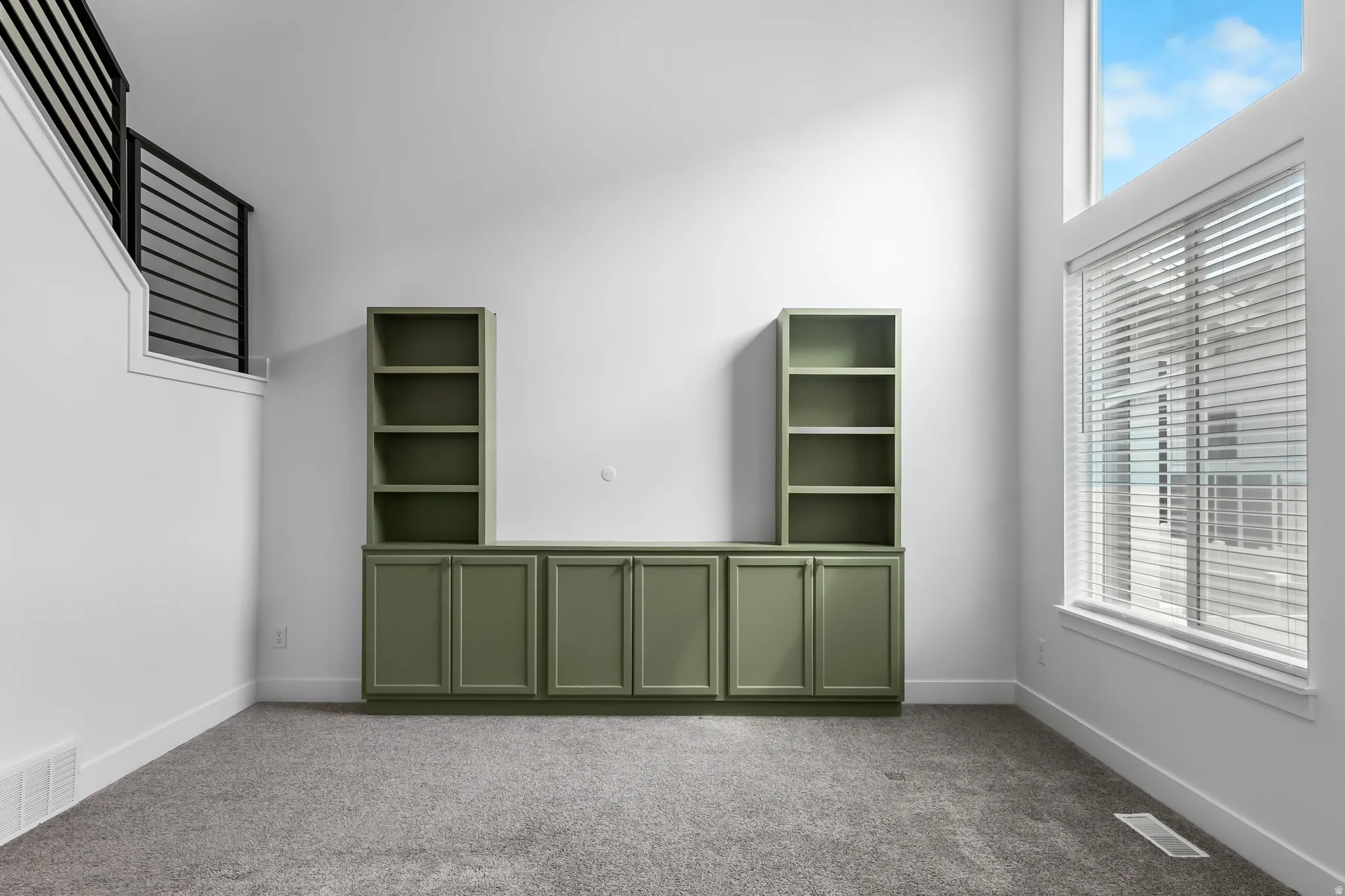 Spare room with carpet and a high ceiling