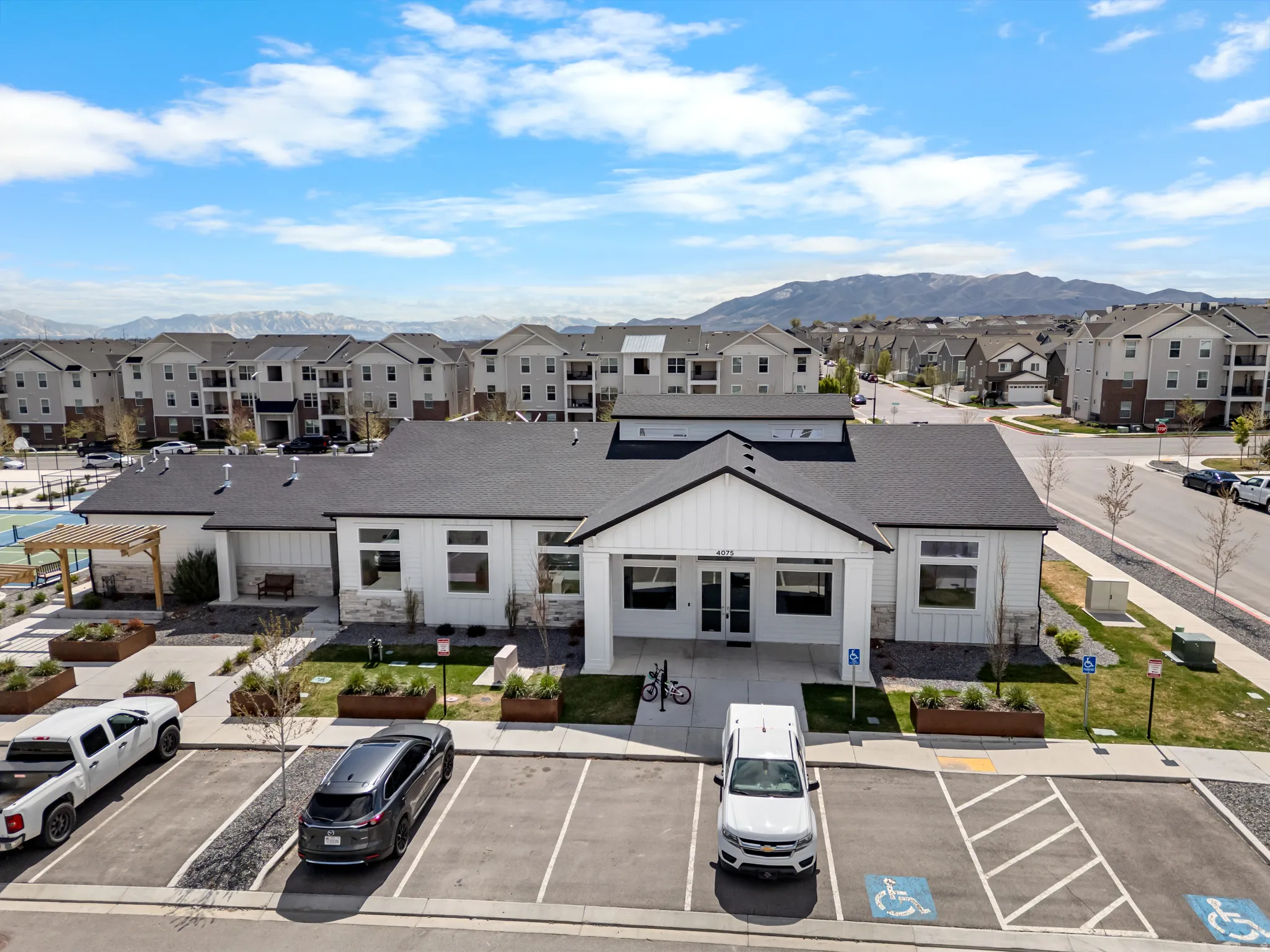 View of property with a mountain view and uncovered parking