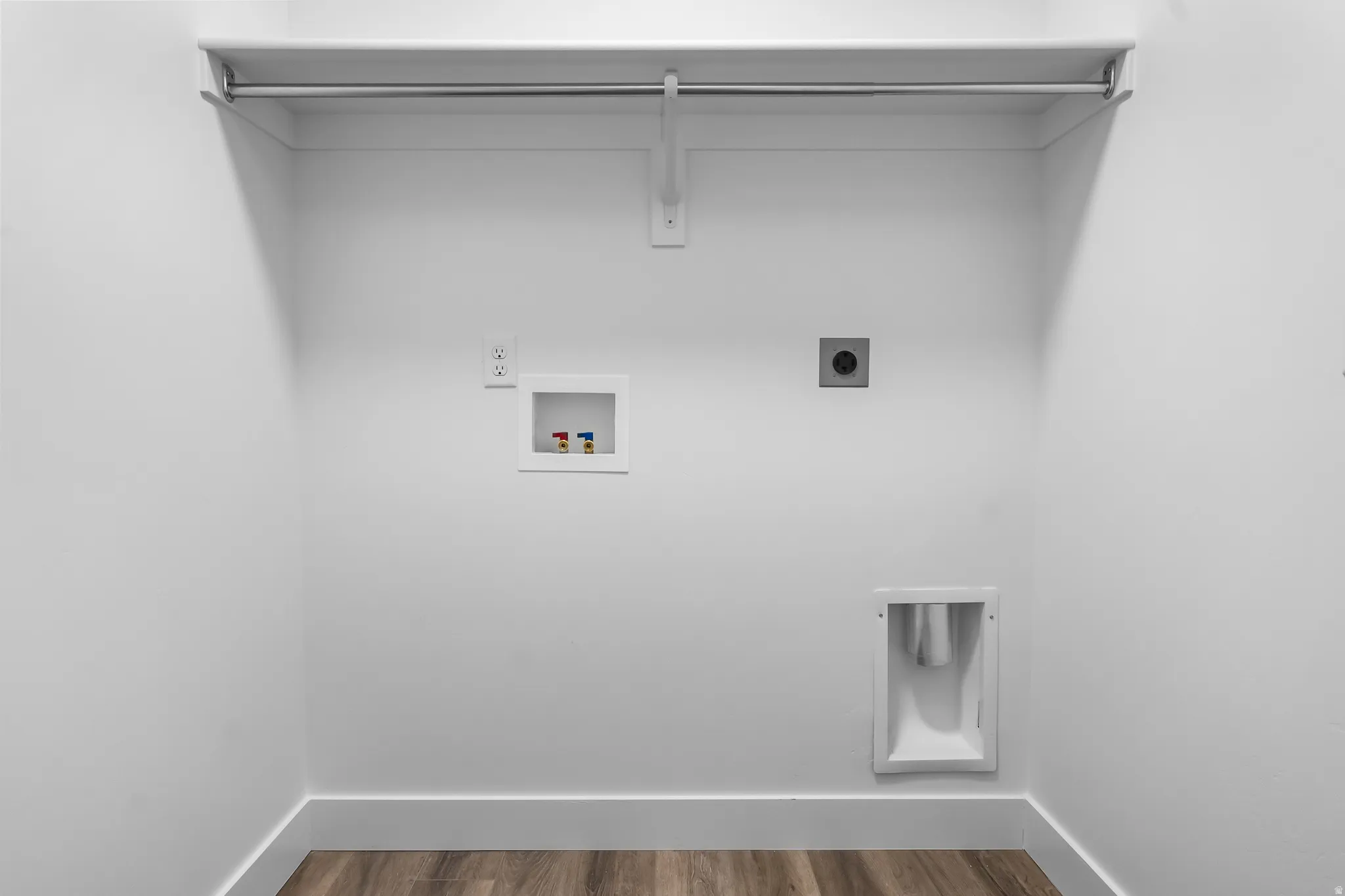 Laundry room featuring hookup for an electric dryer, hookup for a washing machine, and wood finished floors