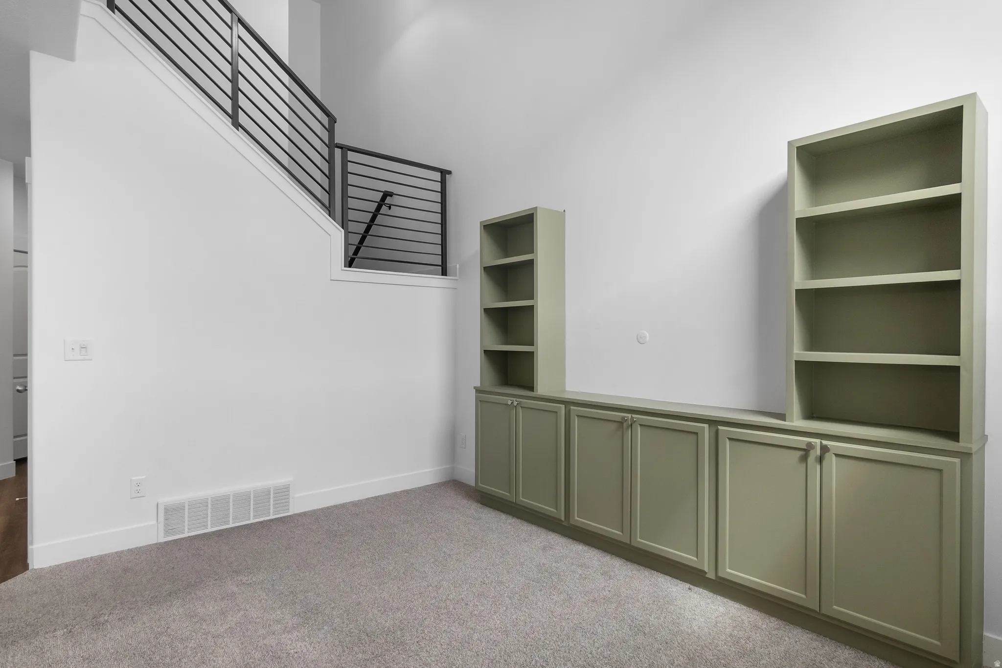 Unfurnished room featuring light carpet