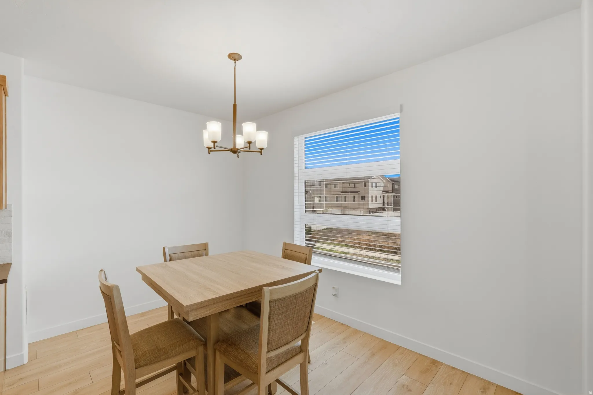 Dining area with a chandelier and light wood-style floors