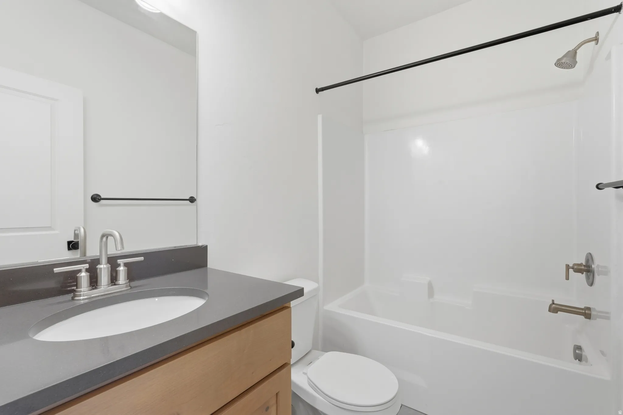 Bathroom featuring vanity and  shower combination