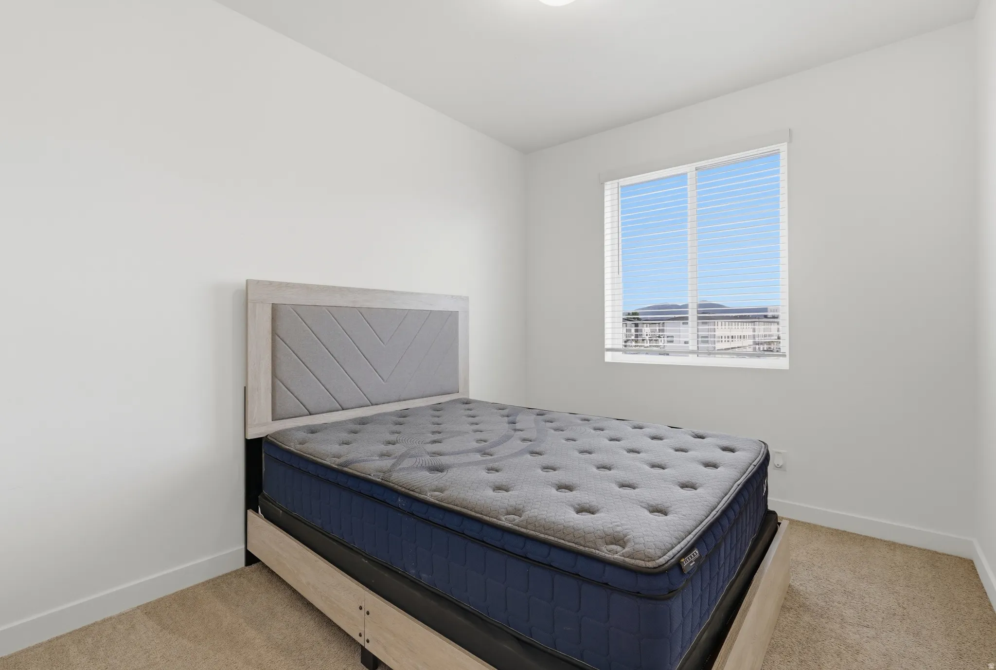 Carpeted bedroom with baseboards