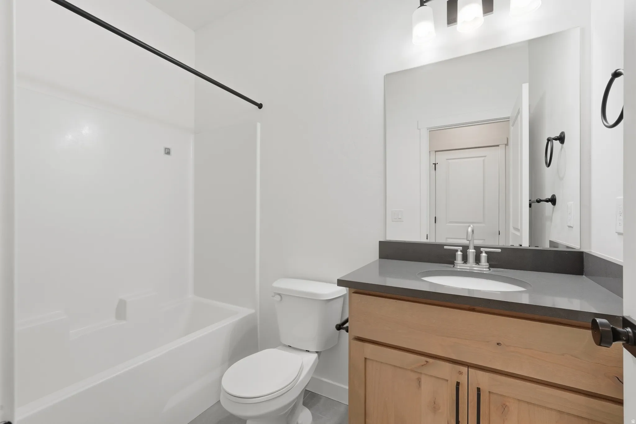 Bathroom featuring vanity and bathing tub / shower combination