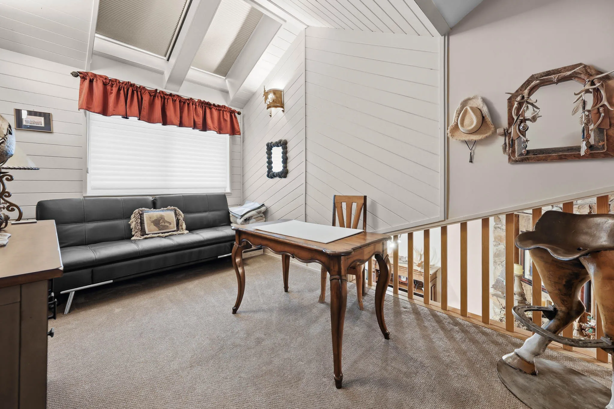 Office area featuring wooden walls, carpet flooring, and vaulted ceiling with beams
