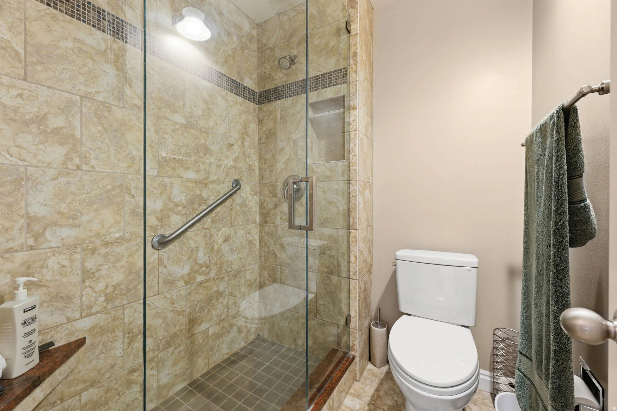 Bathroom featuring a shower stall and toilet