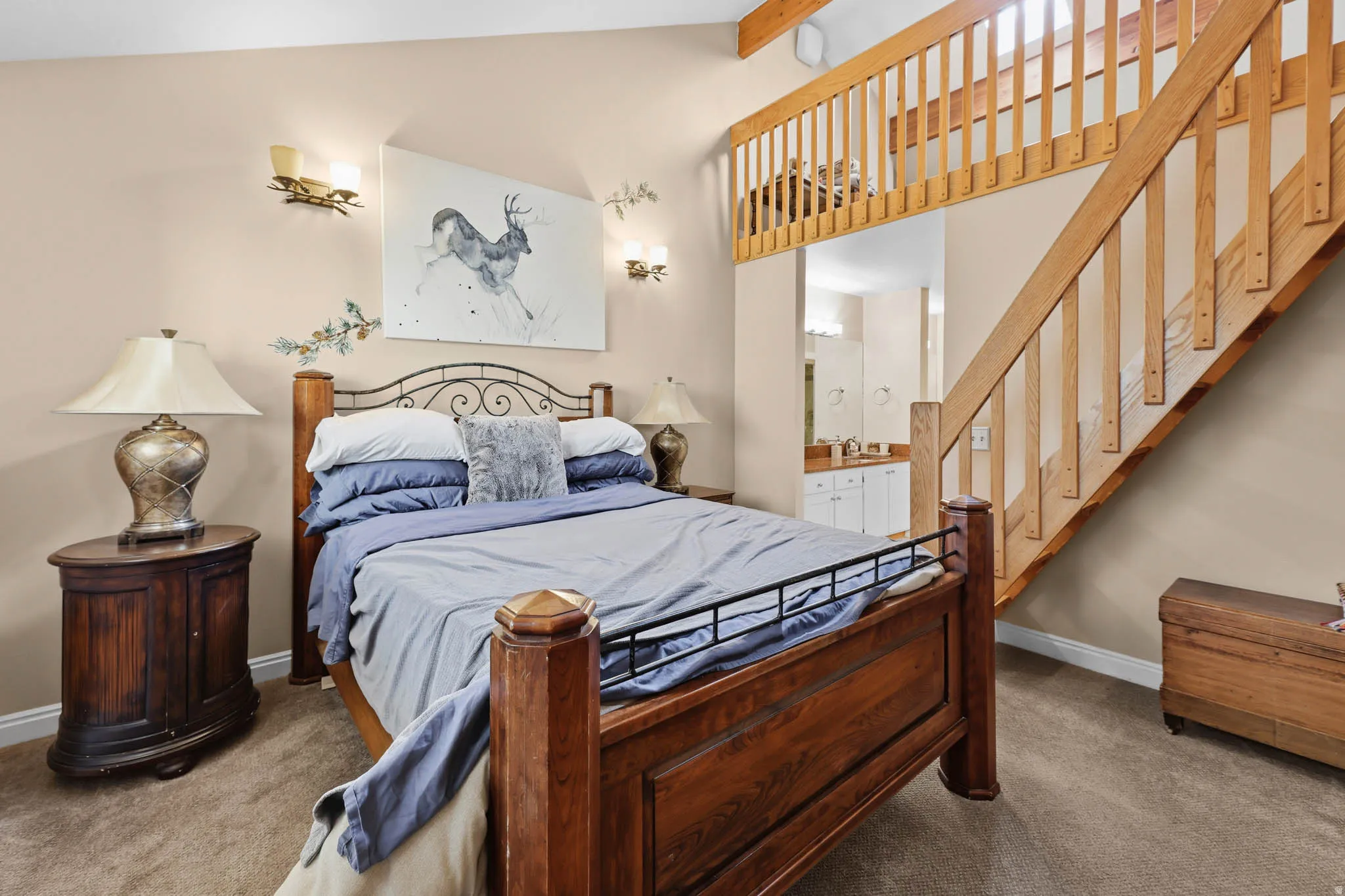 Bedroom featuring lofted ceiling with beams, carpet, and ensuite bathroom