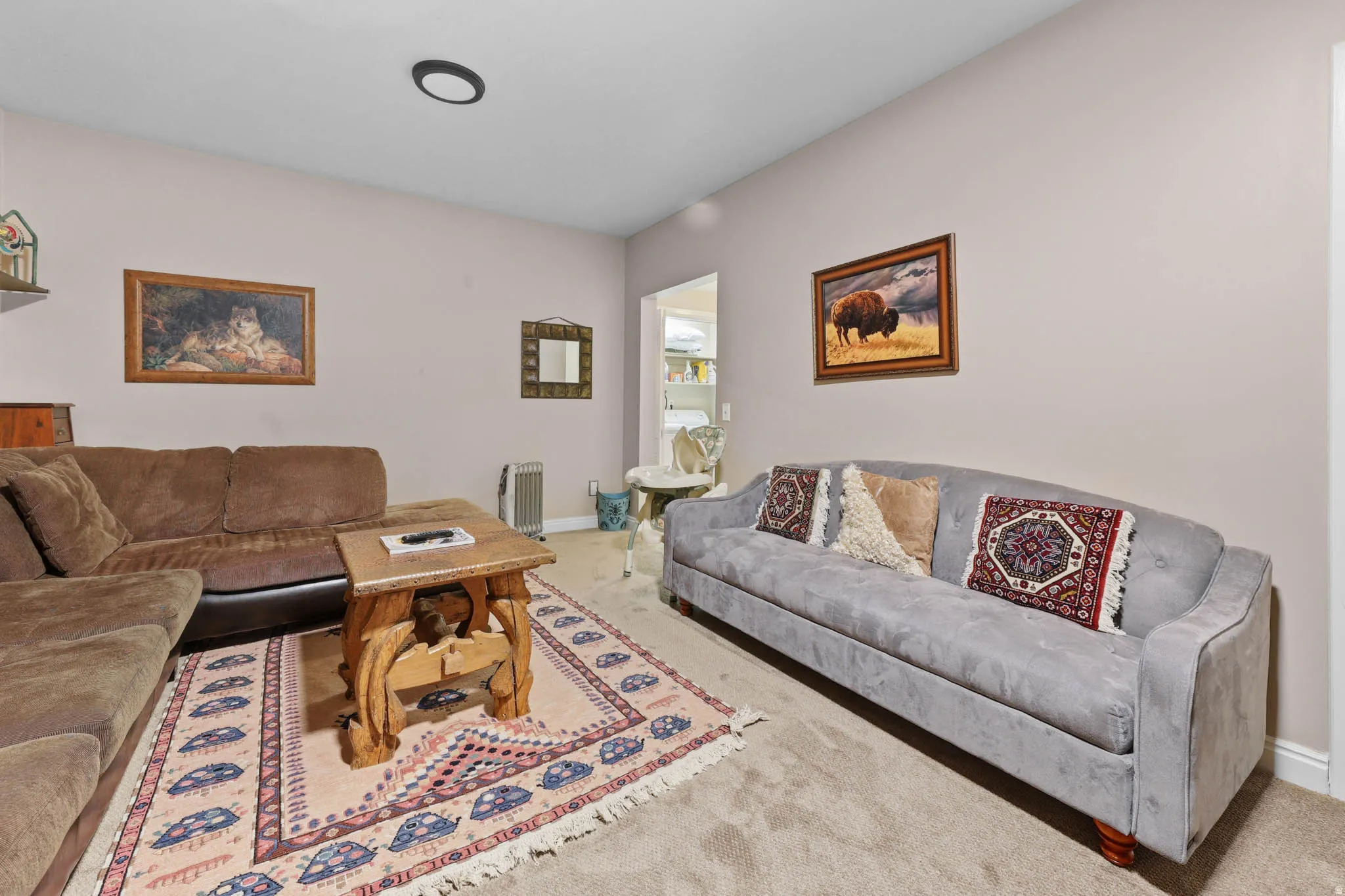 Living area featuring carpet flooring and radiator heating unit