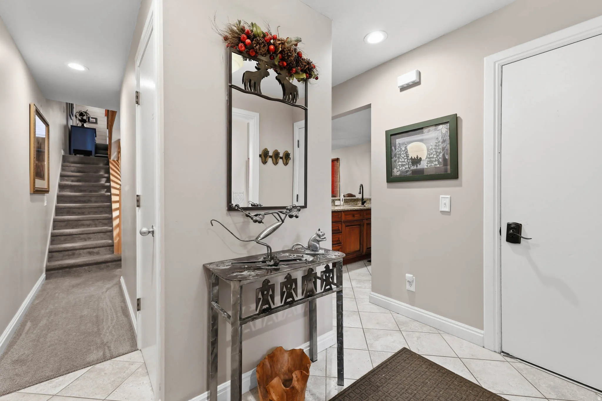 Hall with light tile patterned floors, recessed lighting, and light colored carpet